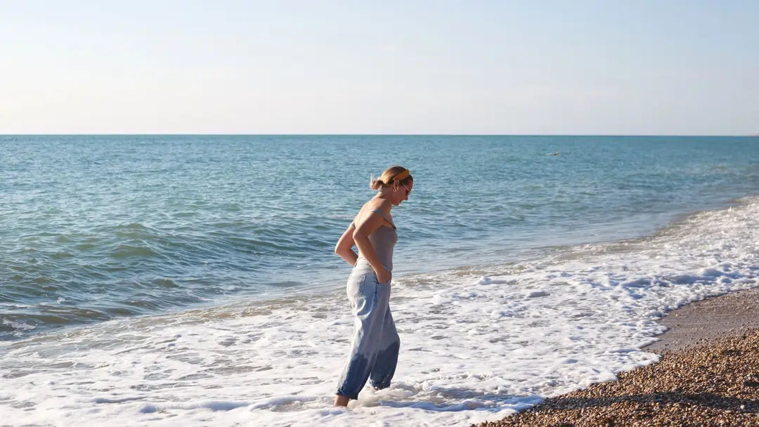 Woman walks on beach in the Summer